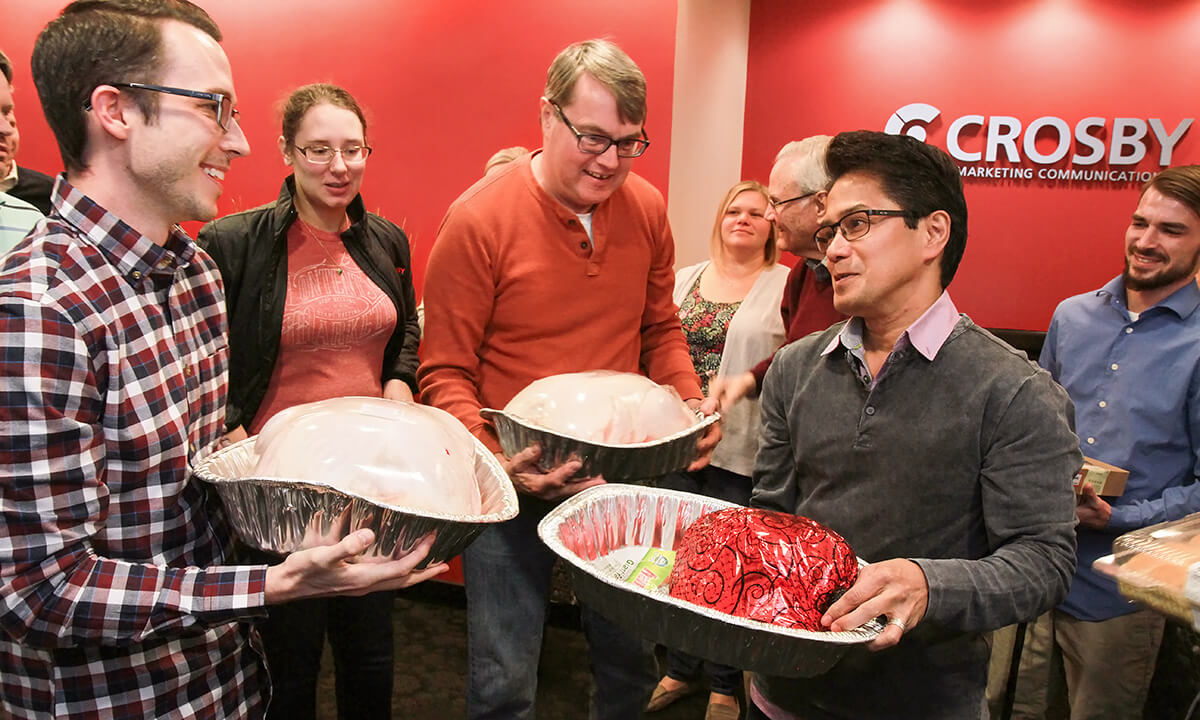 staff holding turkeys